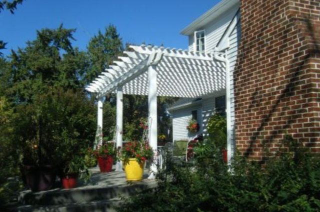 home with a white pergola over their front porch