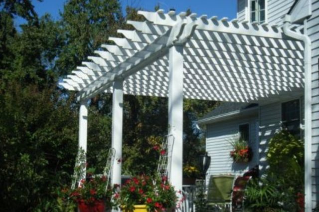 white pergola with posts over a porch
