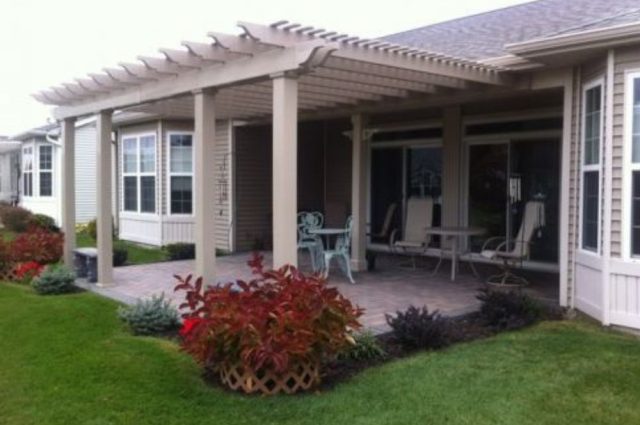 wall mounted pergola with square posts over brick patio area