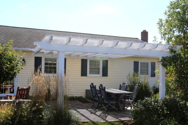 white vinyl pergola attached to a home in denver pa