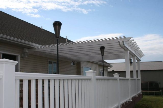 white vinyl railing and pergola attached to home and over and around a two story deck