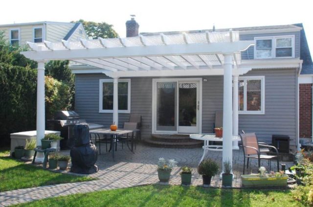 white pergola attached to house and over new patio
