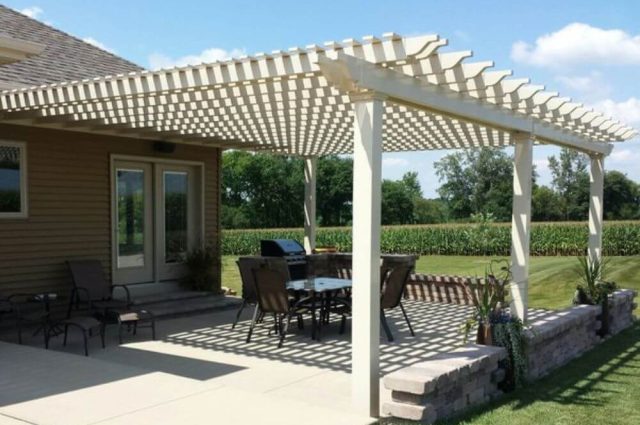 table and chair outdoor furniture over tan attached vinyl pergola