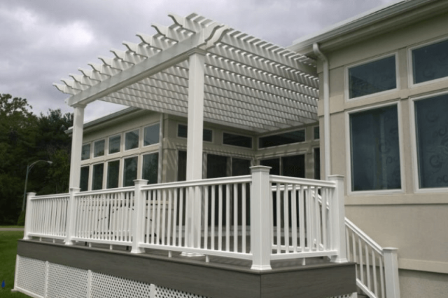 white vinyl pergola over a two story deck with white vinyl railing around it