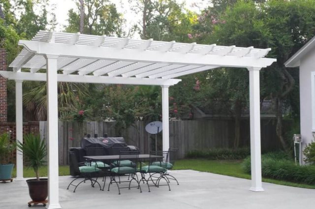 detached white vinyl pergola wtih outdoor seating and chairs