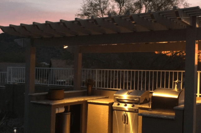 freestanding photo at night over an outdoor kitchen with a small light in gold canyon az