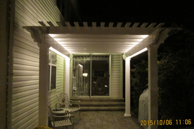 vinyl pergola attached to home in spring city pa at night