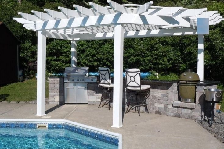 Poolside white pergola with outdoor kitchen