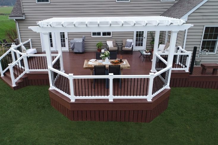 White pergola with brown deck outdoor
