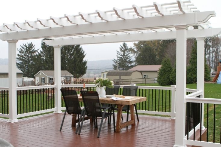 White pergola covering outdoor seating area