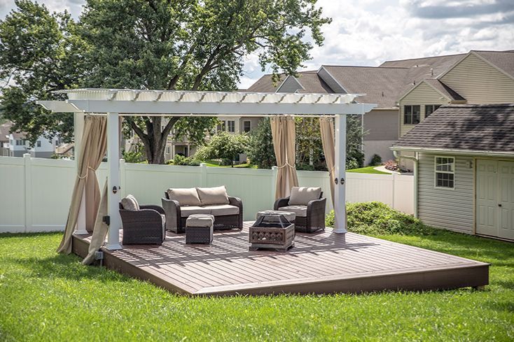 big pergola for sale shown with seating area and side curtains