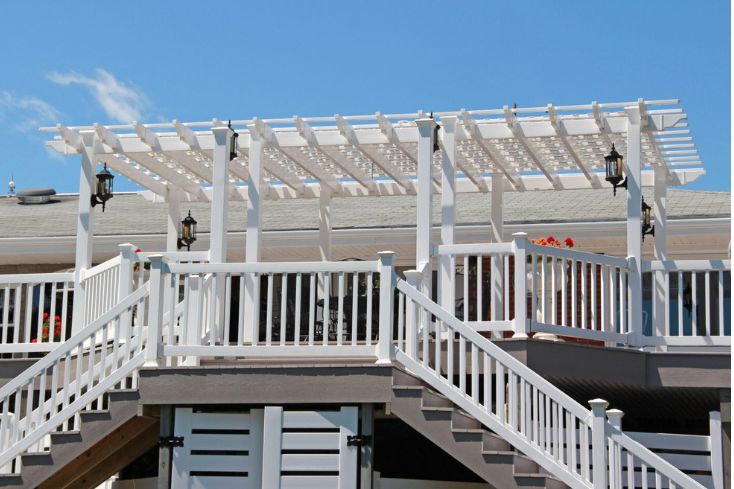 Raised Deck with White Vinyl Pergola Outside