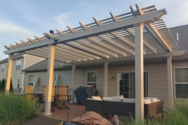 khaki attached pergola over patio area in the backyard attached to the house