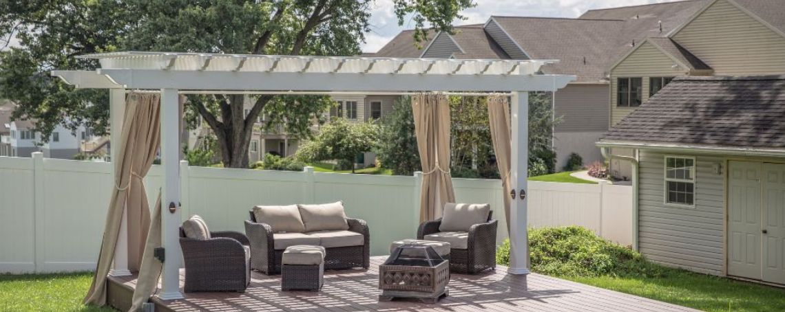 white vinyl modern pergola over an outdoor living area and couches in a backyard