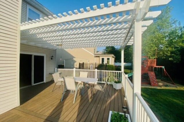 white vinyl pergola over deck with white vinyl railing around the outside of the deck